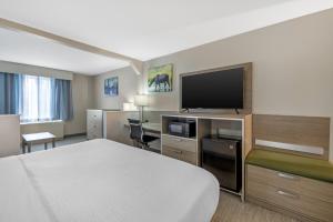 a hotel room with a bed and a flat screen tv at Best Western Plus Pioneer Park Inn in Fairbanks +52 photos