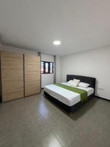a bedroom with a large bed and wooden cabinets at Blanquila Resort in Willemstad +5 photos