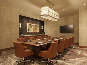 a large conference room with a long table and chairs at Hotel Trinity, Autograph Collection in Austin