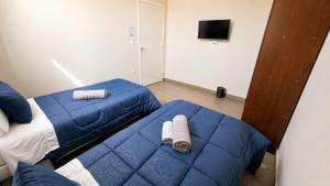 a bedroom with a blue bed and a tv at Casa de Hóspedes Jaú in Jaú +16 photos