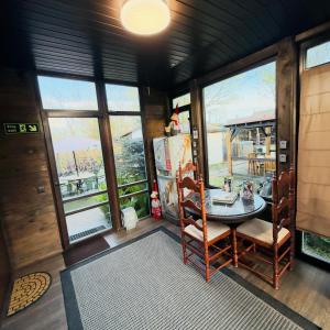 a room with a table and chairs and windows at Vadim Home in Ventspils