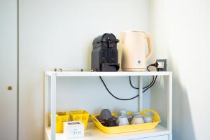a white cabinet with a coffee maker on top of it at Dimora al Glicine in Sernaglia della Battaglia