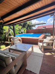 a patio with a pool and a table and chairs at Voilier Bermuda By Villa AGADA in Gourbeyre