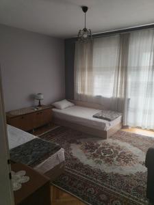 a bedroom with two beds and a window at Magic apartment in Bitola