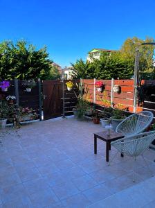 a patio with a bench and a fence with plants at Elia Room & Garden in Kontokali
