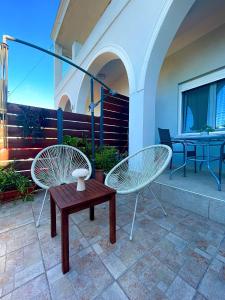 two chairs and a table on a patio at Elia Room & Garden in Kontokali