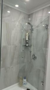 a shower with a glass door in a bathroom at Cozy Queen Room in Quiet Richmond Seafair Area in Richmond +8 photos