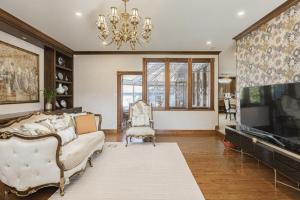 a living room with a couch and a tv at Cozy Queen Room in Quiet Richmond Seafair Area in Richmond