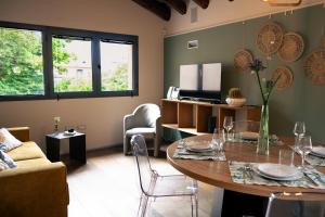 a living room with a table and a couch at Dimora al Glicine in Sernaglia della Battaglia