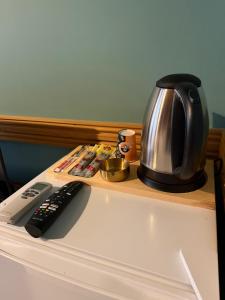 a coffee pot sitting on a counter next to a remote control at Mirello House Otel Tuzla in Tuzla +30 photos