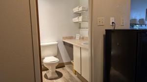 a small bathroom with a toilet and a sink at Moby Dick Inn in Prince Rupert +95 photos