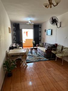 a living room with a couch and a table at Marseilia Resort in Al Ḩammām