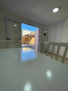 a white kitchen with a large white counter top at Apartment 2 in Apóstoles