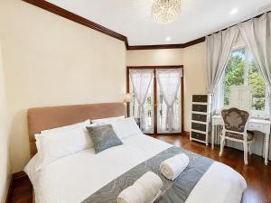 a bedroom with a large bed and a desk at Cozy Queen Room in Quiet Richmond Seafair Area in Richmond