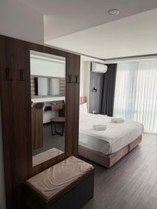 a hotel room with a bed and a mirror at Batumi View Luxury in Adliye