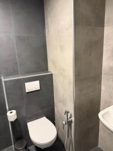 a bathroom with a toilet and a sink at Batumi View Luxury in Adliye +4 photos