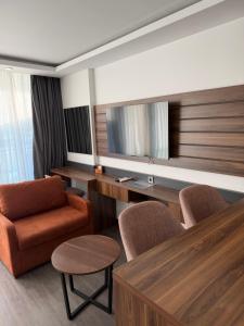 a living room with a couch and chair and a television at Batumi View Luxury in Adliye
