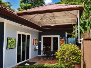 awning over a patio with a table on it at Casa Olas in Quepos
