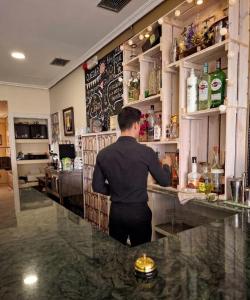 a man standing at a bar at Hostal Dobe in Benavides