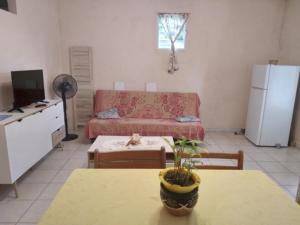 a living room with a couch and a table at ecrin de verdure in Fort-de-France