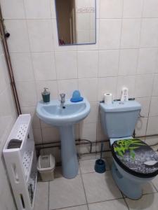 a bathroom with a toilet and a sink at ecrin de verdure in Fort-de-France