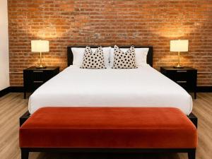 a bedroom with a large bed with two lamps at Brick & Bed Riverfront Lofts, T 202 in Saint Louis