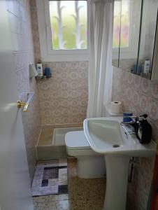 a bathroom with a sink and a toilet and a window at Apartamentos Escorpion Tossa de Mar in Tossa de Mar +45 photos