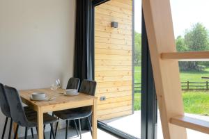 a dining room with a table and chairs and a window at Domovi Gorjanke - Gorjanka homes in Ajdovščina