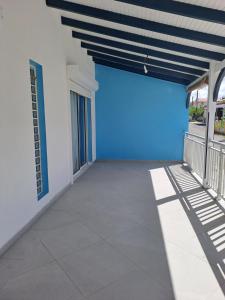 a large garage with a blue door on a building at La Casamarie in Saint-Louis