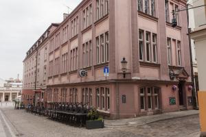 a large building on the side of a street at Sleep in Hostel & Apartments Stary Rynek in Poznań