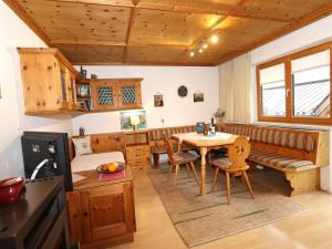 a kitchen and dining room with a table and a couch at Veronika in Fulpmes +9 photos