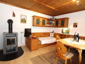 a bedroom with a bed and a wood stove at Veronika in Fulpmes