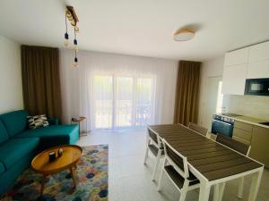 a living room with a table and a blue couch at Apartmany Vir DaRa in Vir