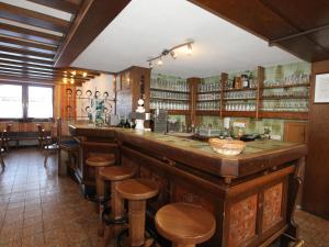 a bar in a restaurant with wooden stools at Bergheimat S in Huben