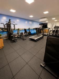 a gym with several treadmills and machines in a room at Alugueasy - EASY Noroeste in Brasília