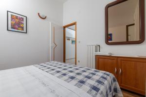 a bedroom with a bed and a mirror at Apartment Zavala 553d in Jelsa +30 photos