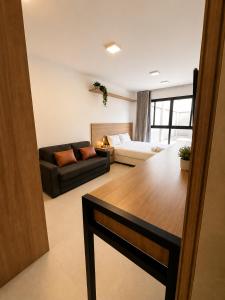 a living room with a bed and a couch at Alugueasy - EASY Noroeste in Brasília