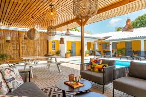 an outdoor patio with furniture and a pool at J&L Resort in Willemstad