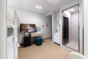 a bathroom with a shower and a sink and a mirror at lazy tiger hotel in Seoul
