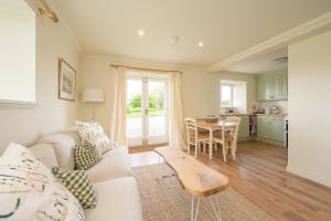 a living room with a couch and a table at Cardross Holiday Cottages in Arnprior