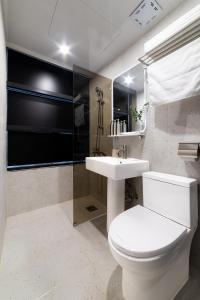 a bathroom with a white toilet and a sink at lazy tiger hotel in Seoul +63 photos