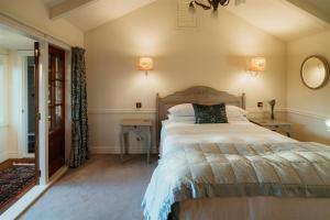 a bedroom with a large bed and a mirror at Aldourie Lodge - Lake Tekapo in Lake Tekapo