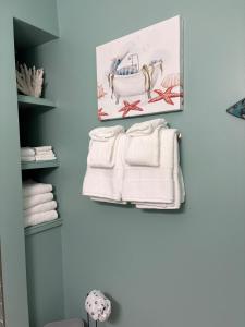a bathroom with white towels hanging on a wall at Waves, Sun & Relaxation Retreat in Clearwater Beach +78 photos