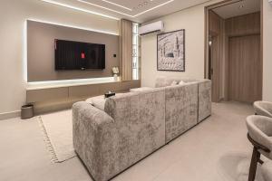 a living room with a couch and a flat screen tv at دار المصطفى in Al-Salam