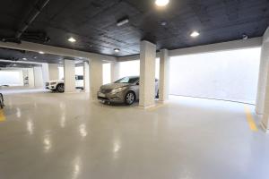 a parking garage with two cars parked in it at دار المصطفى in Al-Salam