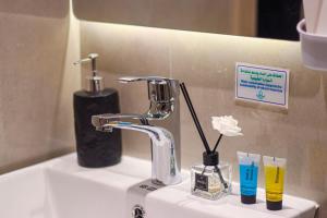 a bathroom sink with a faucet and a toothbrush at دار المصطفى in Al-Salam +23 photos