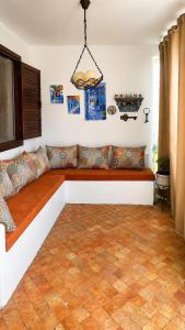 a couch in a living room with at Plage al amin eden in Fnidek