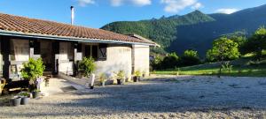 a building with potted plants in front of it at Teranga in Artigues