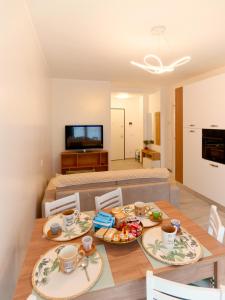 a dining room with a table with two plates of food at Assisi valley - Modern Apartment with Covered Parking in Bastia Umbra
