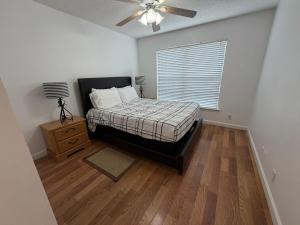 a bedroom with a bed and a ceiling fan at House 210 Brunswick in Brunswick